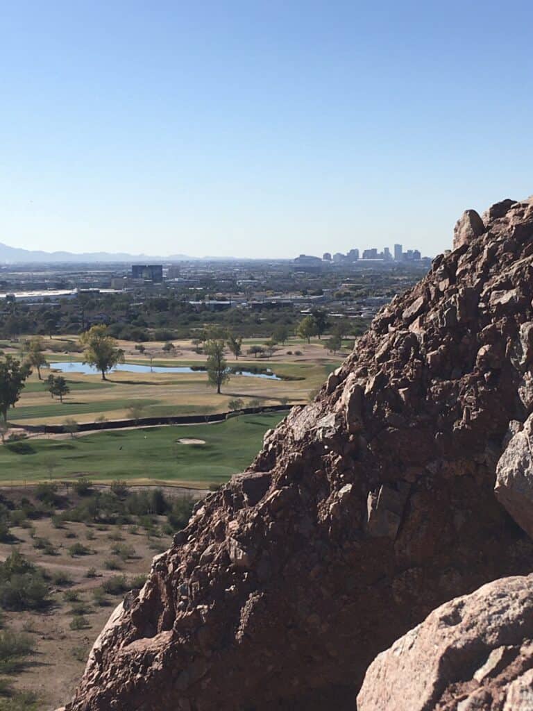 photo of the rocks we were on in the foreground, golf course in the middle ground, Phoenix skyline in the background
